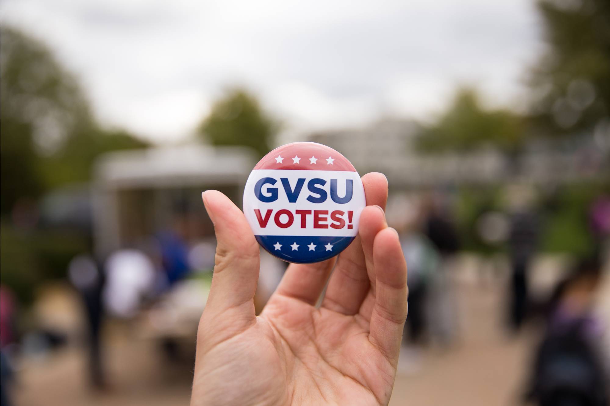 Red and blue button with text GVSU Votes